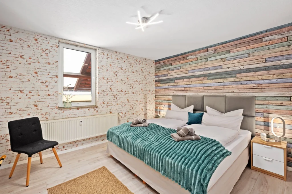 Bedroom 1 with wood-panel wall
